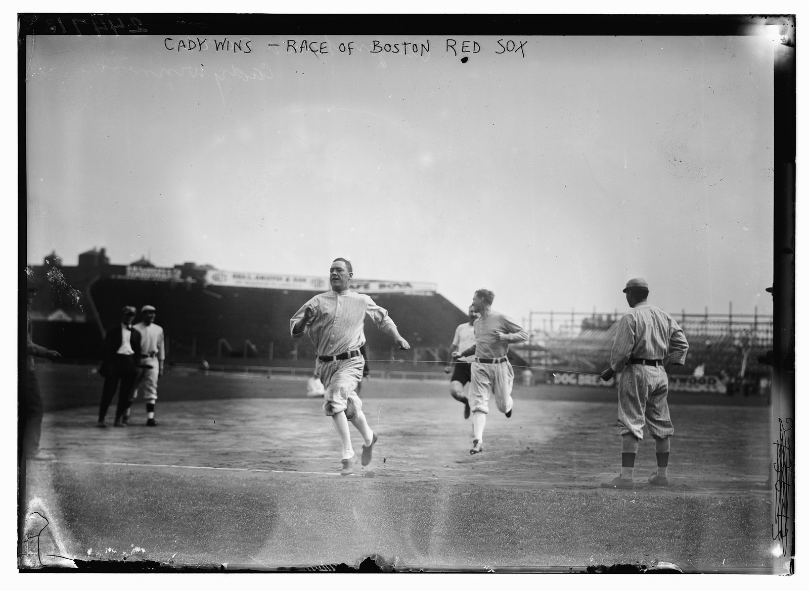 Hick Cady of Boston Red Sox wins foot race with Jack O'Brien (Boston Red Sox trainer, pin shorts, partially obscured) and teammate Buck O'Brien (looking to his right) at Fenway Park, Boston (baseball), [1912 Sept. 25] — historic photograph