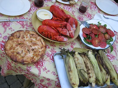Lobster dinner with apple pie, corn and tomato salad
