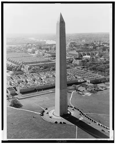 Aerial view of Washington Monument, with temporary war buildings in distance