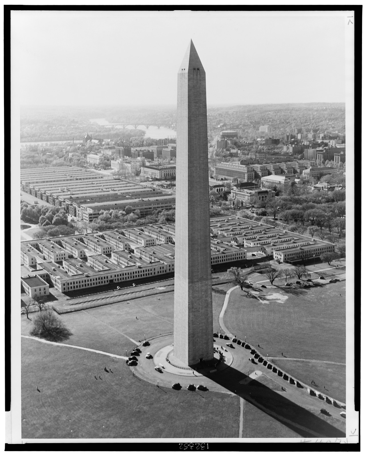 Aerial view of Washington Monument, with temporary war buildings in distance, [1943] — historic photograph
