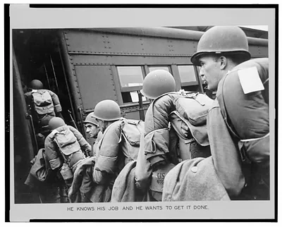 New York Port of embarkation during World War II. He knows his job and he wants to get it done