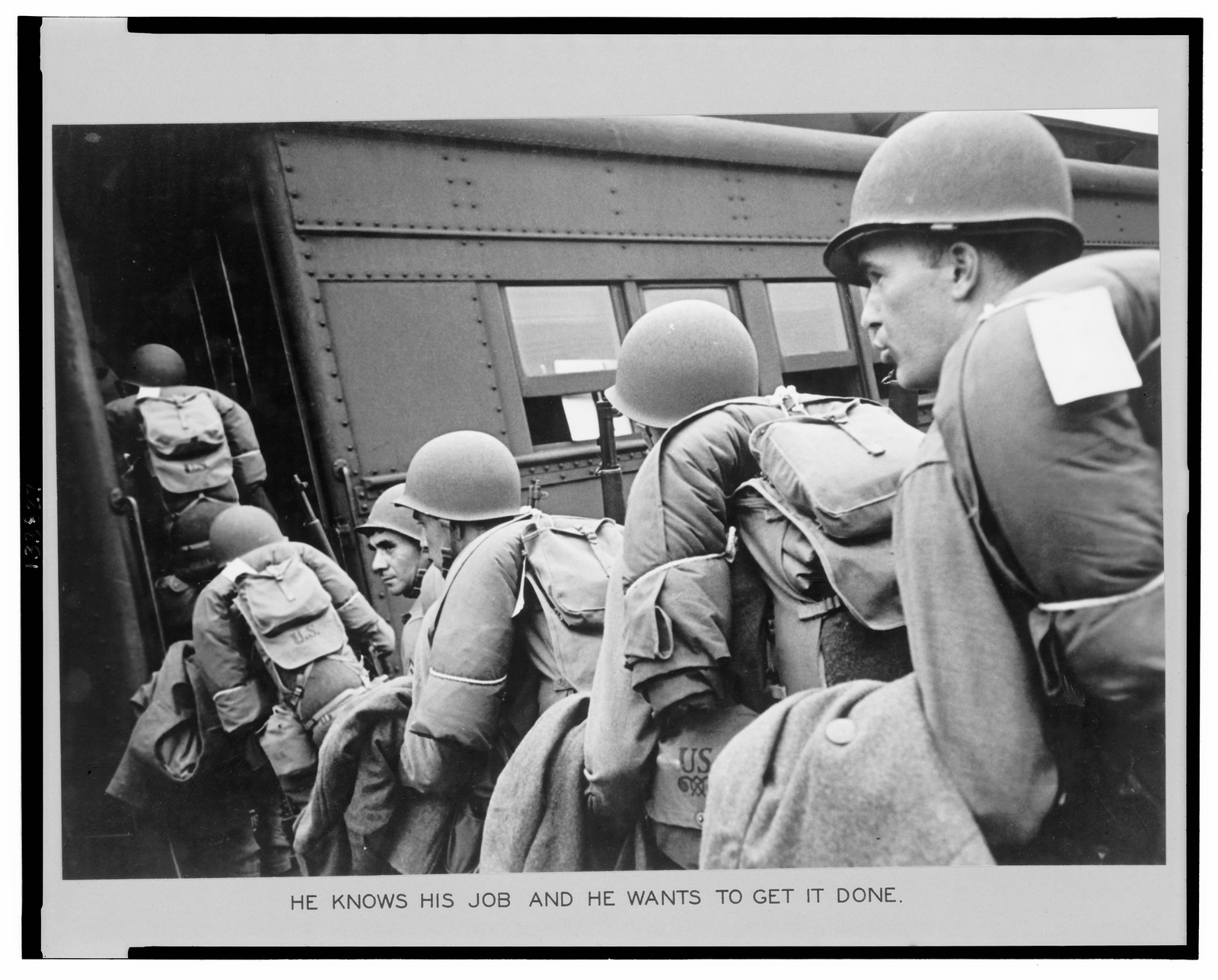 New York Port of embarkation during World War II. He knows his job and he wants to get it done — historic photograph