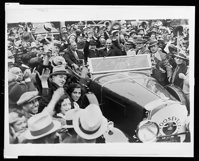 [Franklin D. Roosevelt riding in a convertible with son James and an unidentified man during Roosevelt's visit to Rochester, N.Y., to begin his presidential campaign]