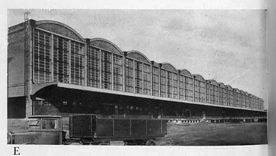 Long glazed hall with arched bays and a lorry