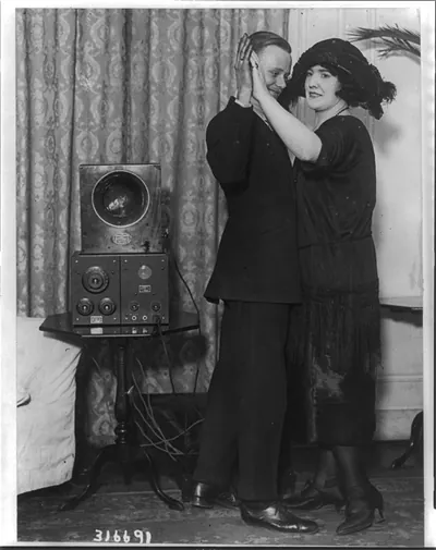 Hotel Vanderbilt installs radio phone receiving set. Mr. E.C. Pickward and partner enjoying a wireless fox trot in the Della Robbia Room of the Vanderbilt