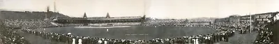 Panoramic photograph of a baseball game in a crowded stadium