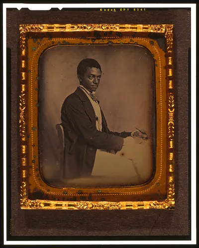 [James B. Yates, three-quarter length portrait, three-quarters view, seated in chair at desk]