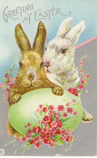 Greeting at Easter, two rabbits with egg and flowers