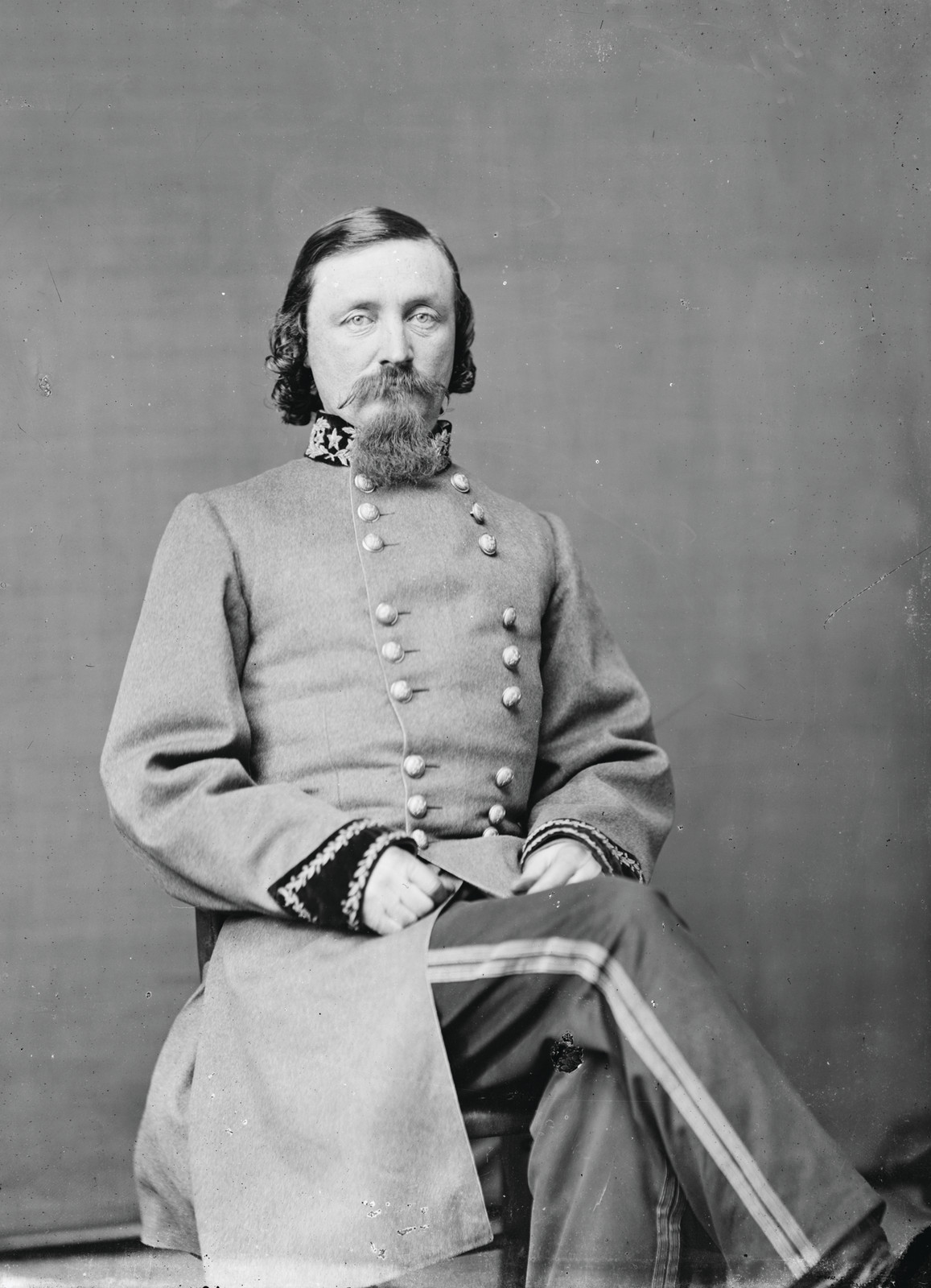 Seated Confederate officer in gray uniform, studio portrait — historic image