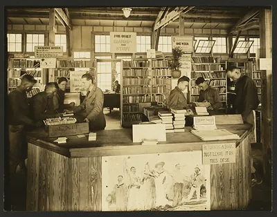 Circulation desk at Camp Sevier library, with soldiers reading and returning books