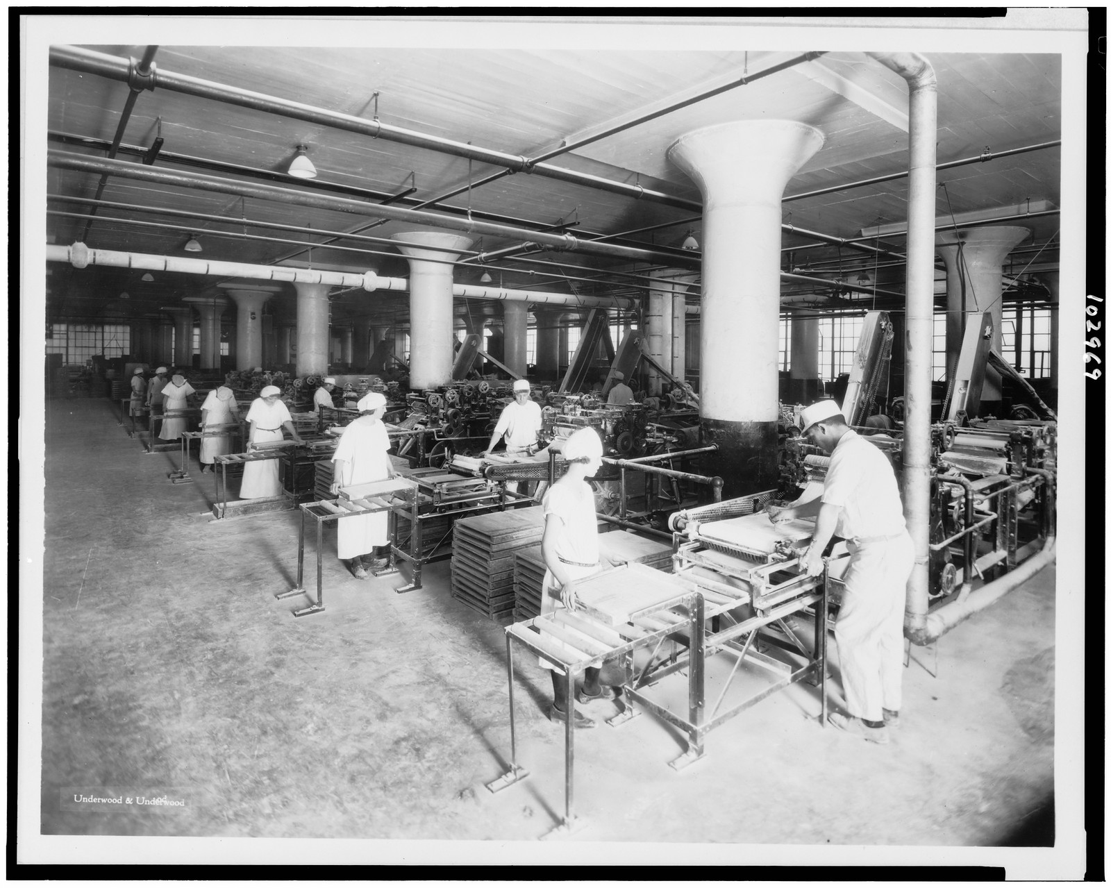 Shaping gum at the American Chicle Company plant / Underwood & Underwood., c1923. — historic photograph