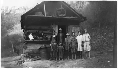 [Mountain family in front of log cabin, Berea, Ky., Dec. 1931]