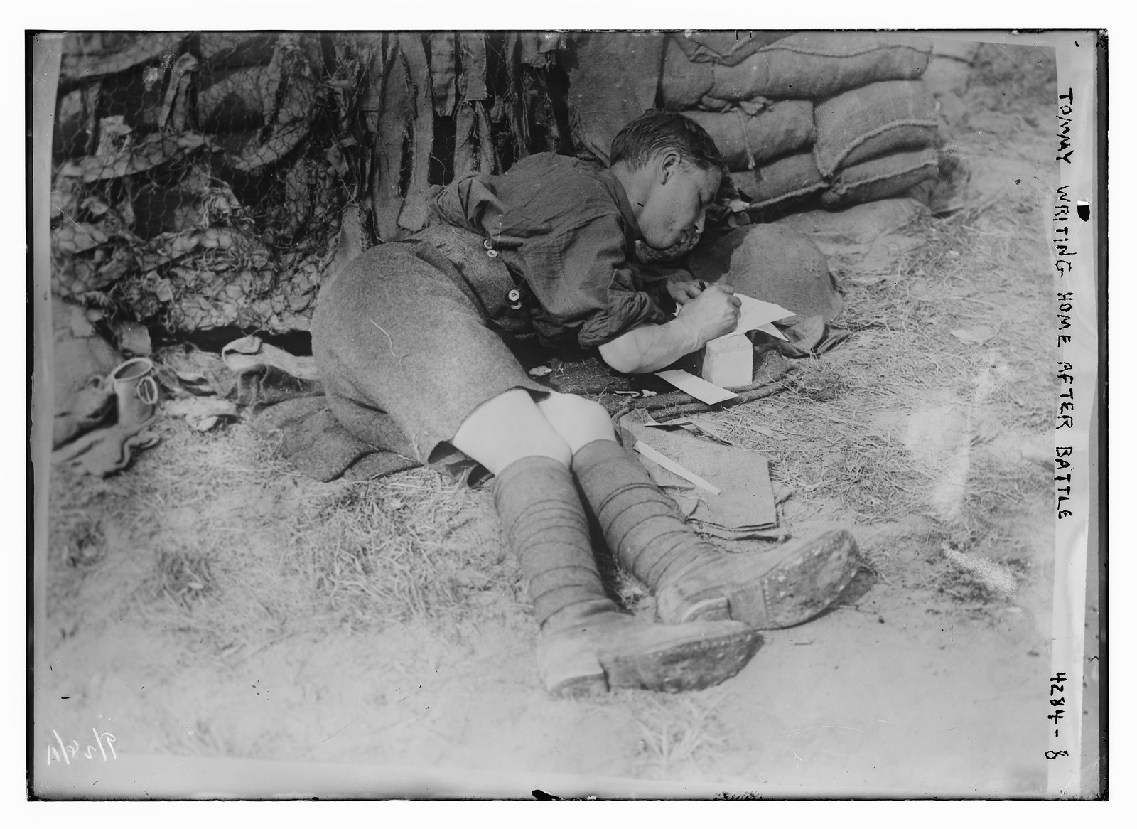 Tommie writing home after battle, n/a — historic photograph