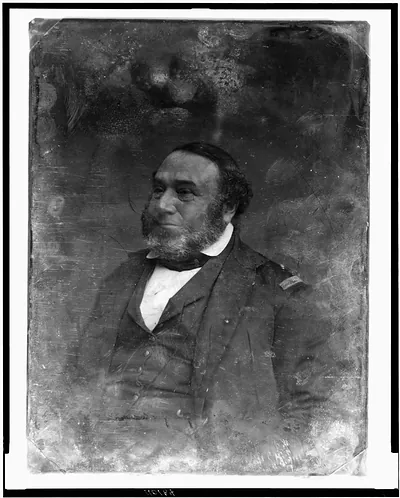 Bearded man in dark coat with shoulder strap, early portrait