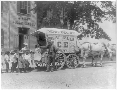 [Kennebec Ice horse-drawn wagon parked in front of Birney Public School - school children lined up with teacher behind wagon as man shows them large chunk of ice suspended by tongs, Washington, D.C.]