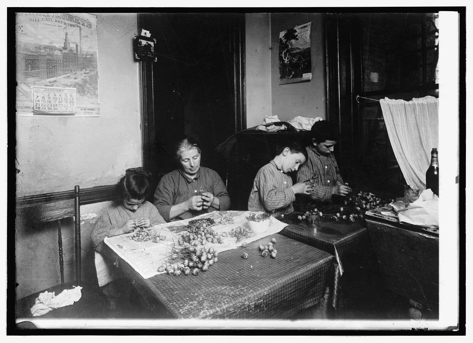 Making artificial flowers in a New York tenement house, [between 1909 and 1919] — historic photograph