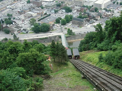Incline railway cars on a steep track above a town