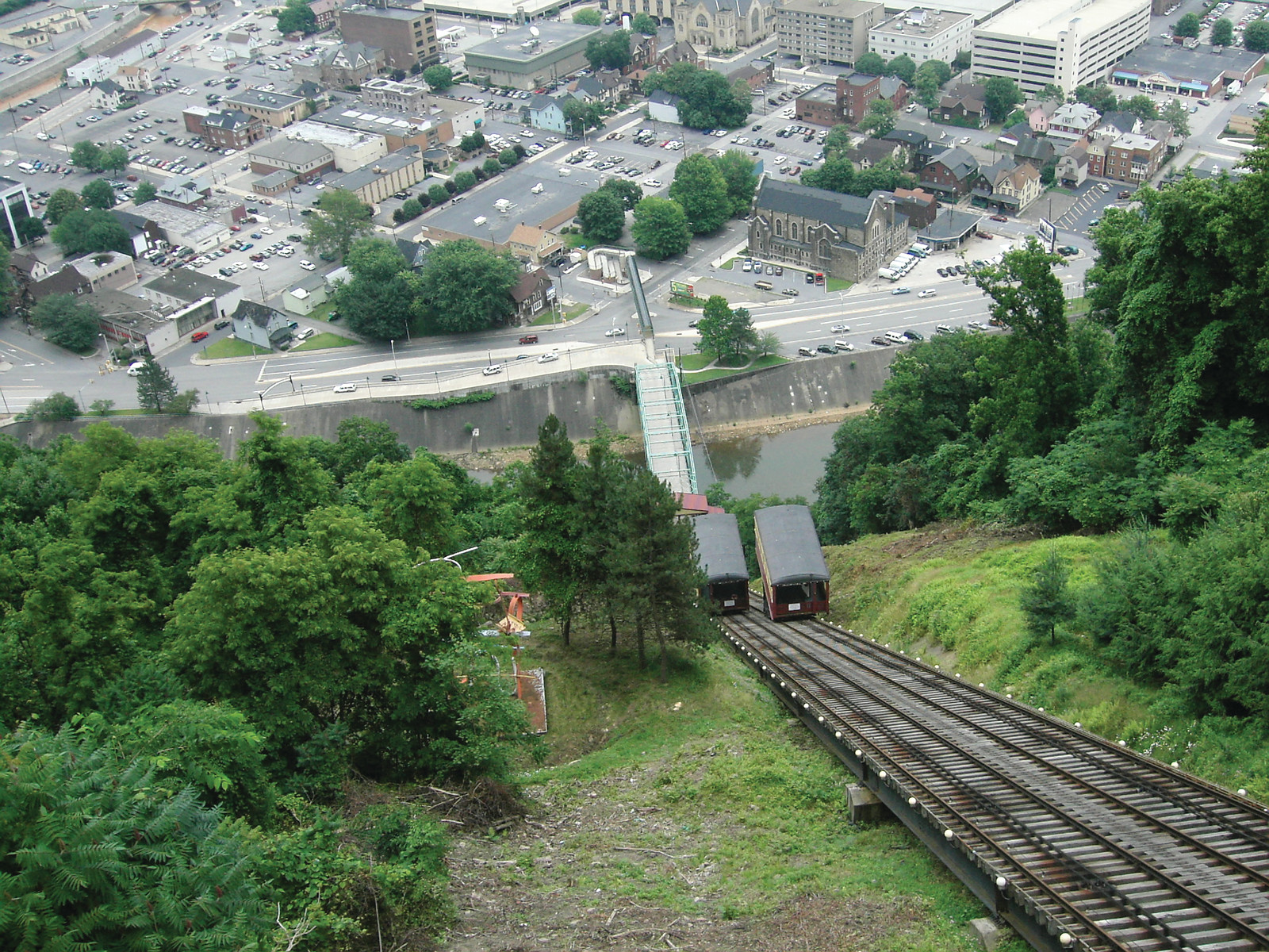 Incline railway cars on a steep track above a town — historic image