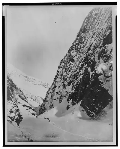 Men traveling with horses through snow covered valley