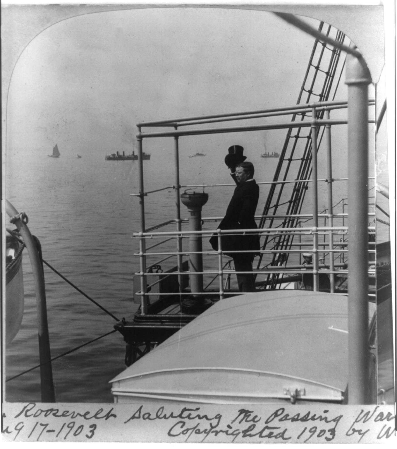 Pres. Roosevelt saluting the passing war ships--Review of war fleet at Oyster Bay, Aug. 17, 1903, c1903. — historic photograph