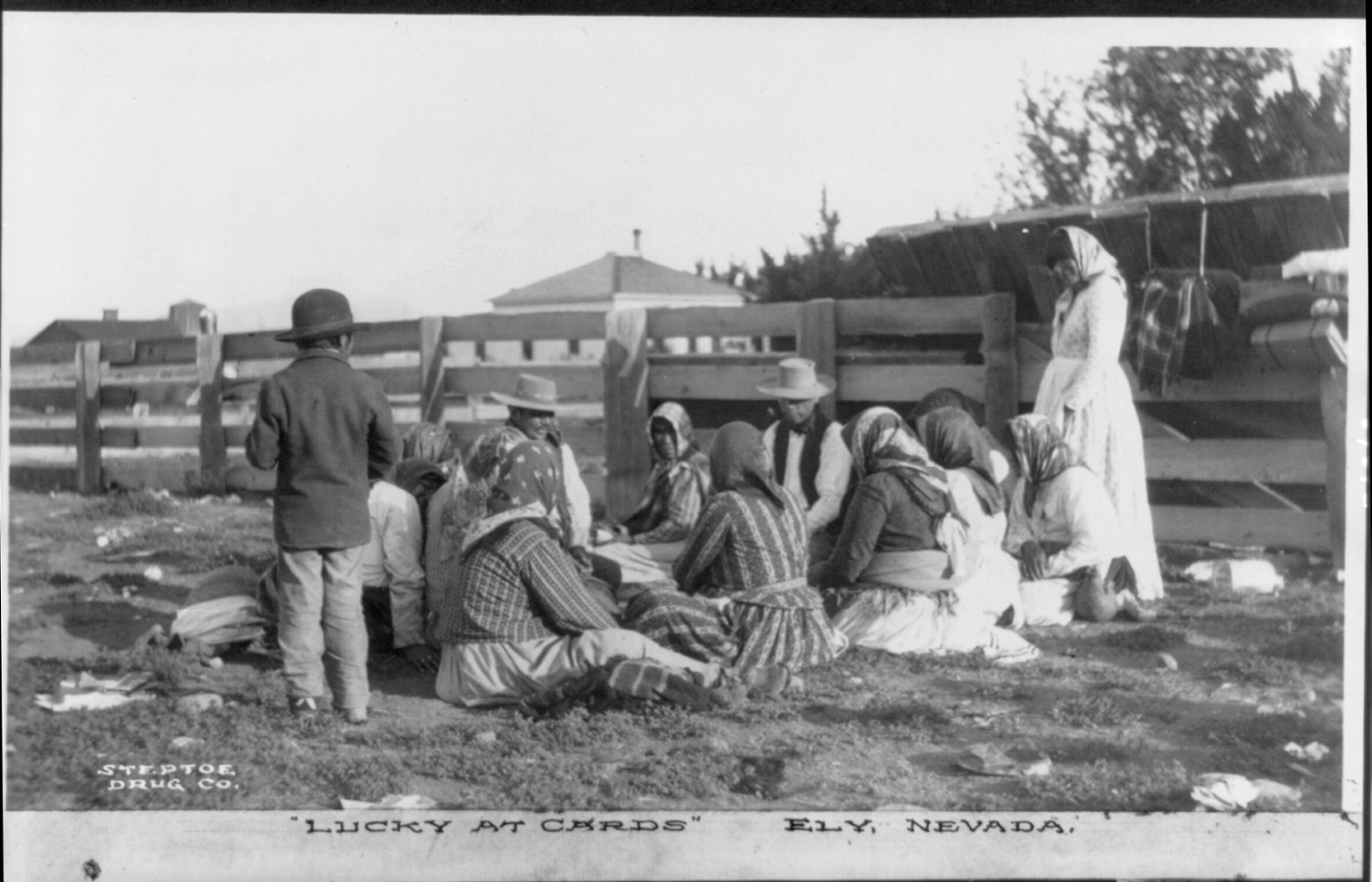 Indians gambling outdoors, seated on ground and playing cards, Ely, Nevada: Lucky at cards, ca1910. — historic photograph
