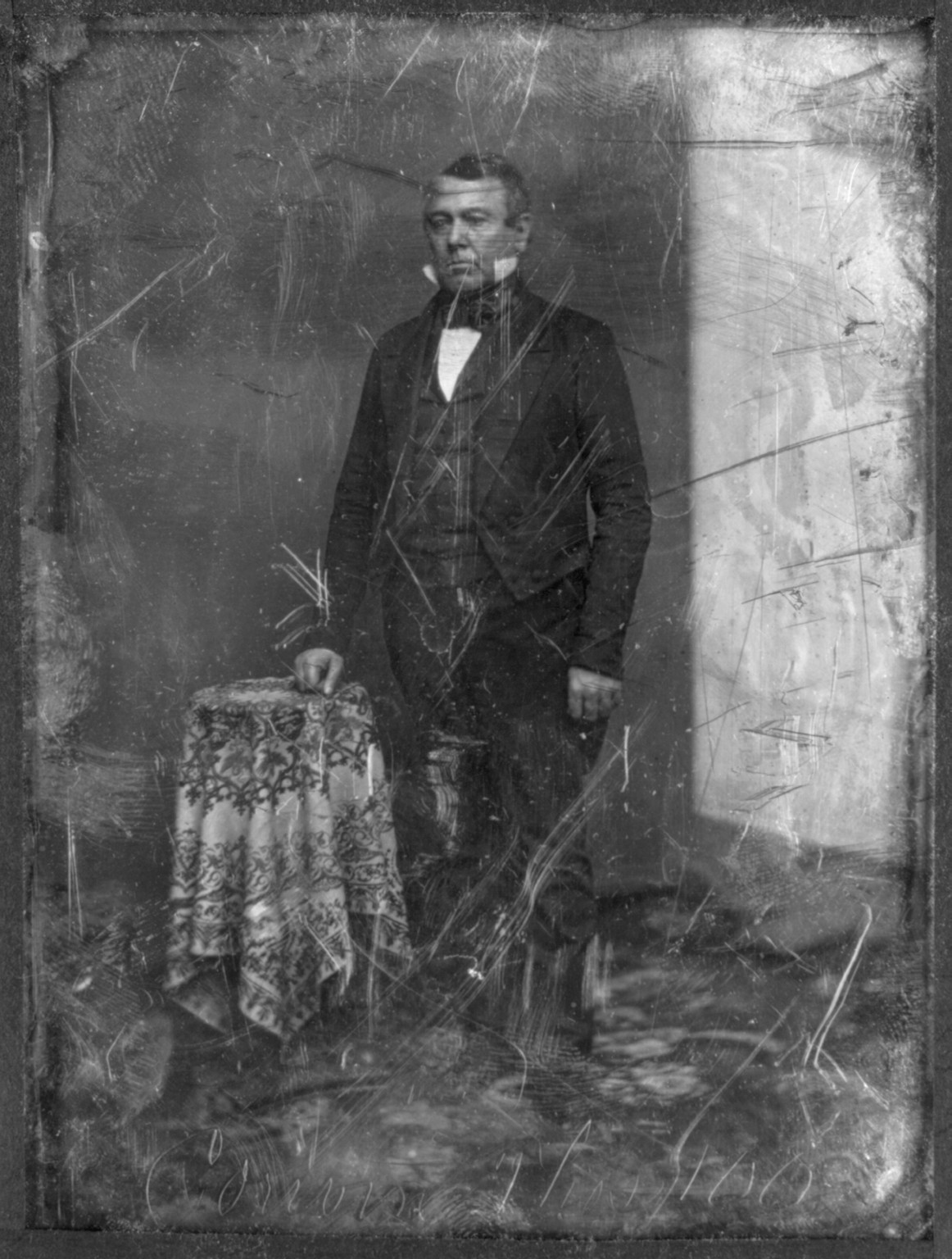[Thomas Corwin, full-length portrait, three-quarters to the left, standing by table with tablecloth, backdrop or reflector screen prominent on left], [between 1850 and 1860] — historic photograph