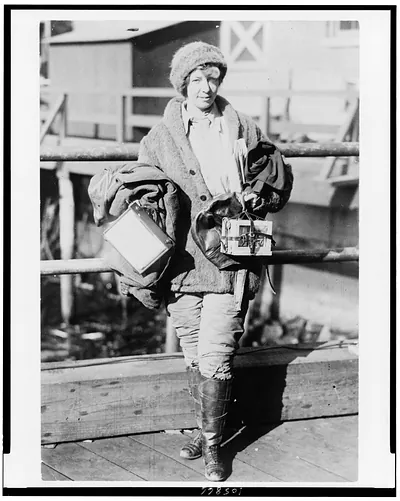 [Miss Ruth Law, aviator, full-length portrait, standing, facing slightly right, carrying two boxes, one the map case she designed] / Herbert Photos, New York.