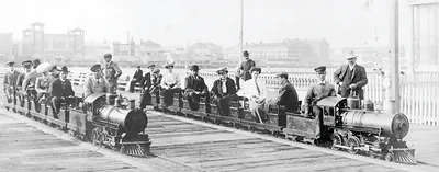 [People on two miniature railroad trains on bridge or pier, possibly at Dreamland, Coney Island, New York City]