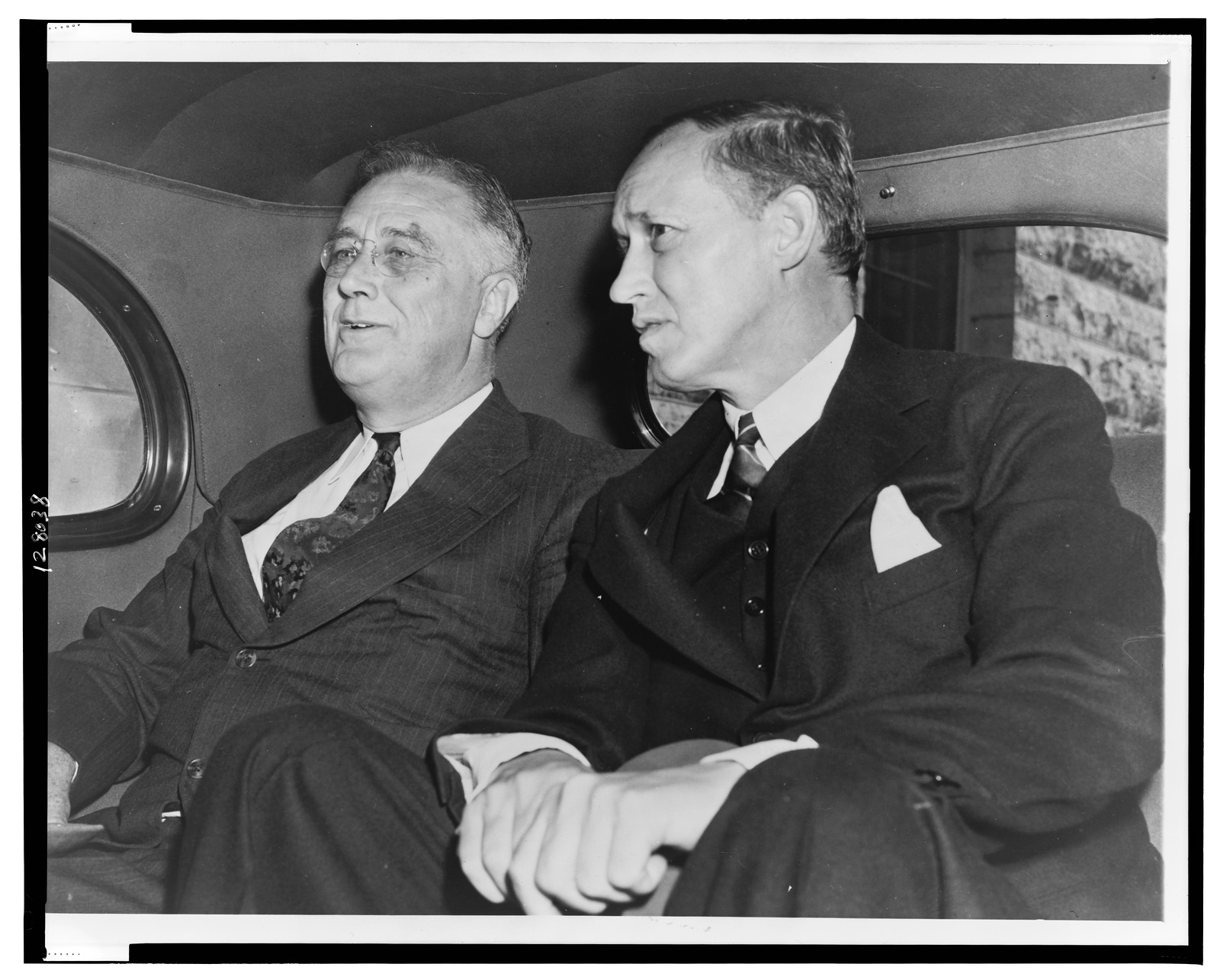 [President Franklin D. Roosevelt (left) with Harry Hopkins in back seat of an automobile in Rochester, Minn., after visiting son James Roosevelt in hospital] — historic photograph