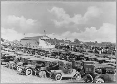 Early model automobiles in fair grounds parking lot, Owosso, Michigan