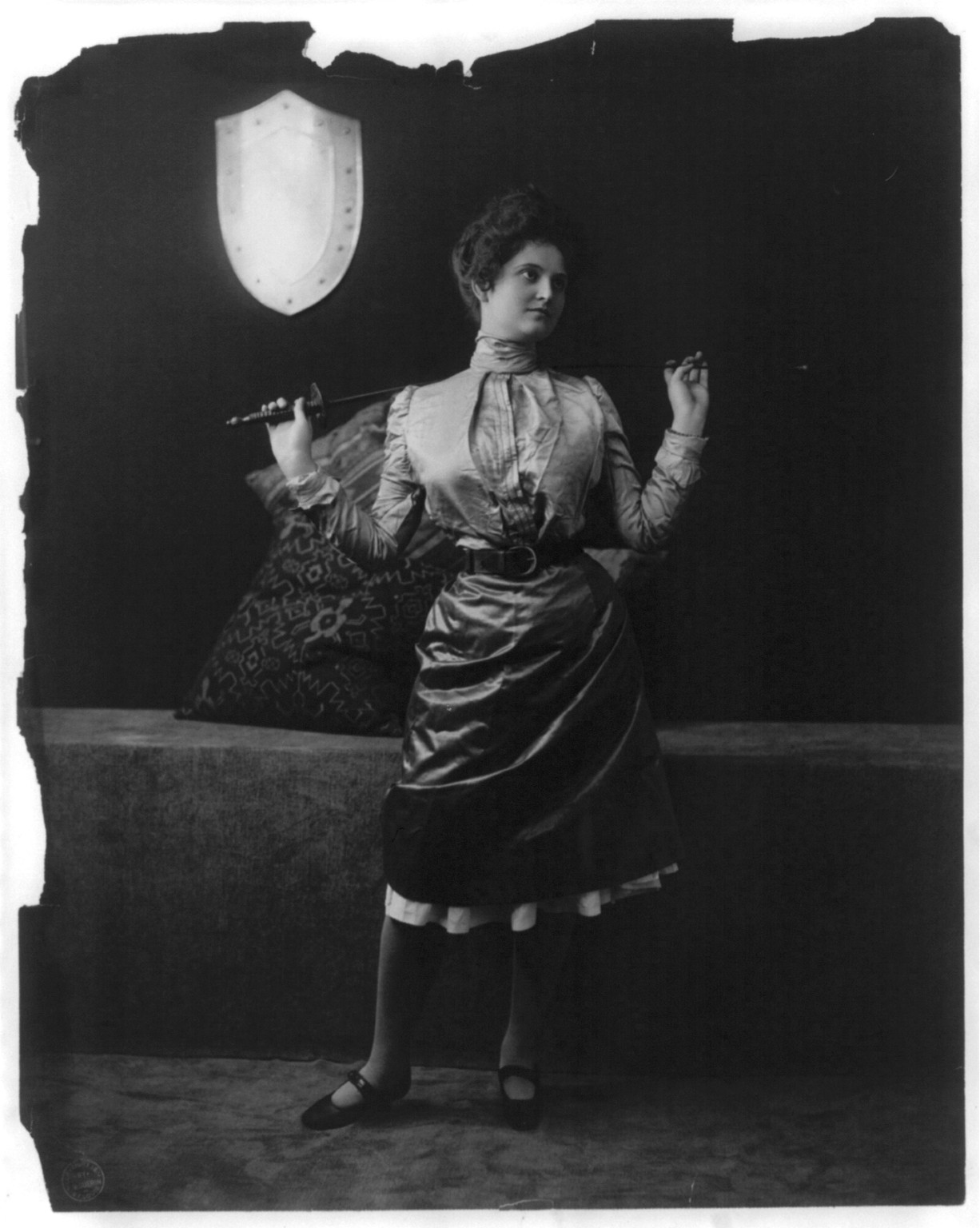 [Young women modeling: full lgth., holding sword behind shoulders], c1901. — historic photograph