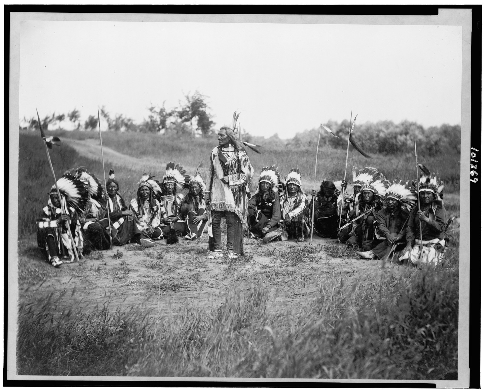 [Chief Little Wound in council with other Indians, wearing feather headdresses], c1899. — historic photograph