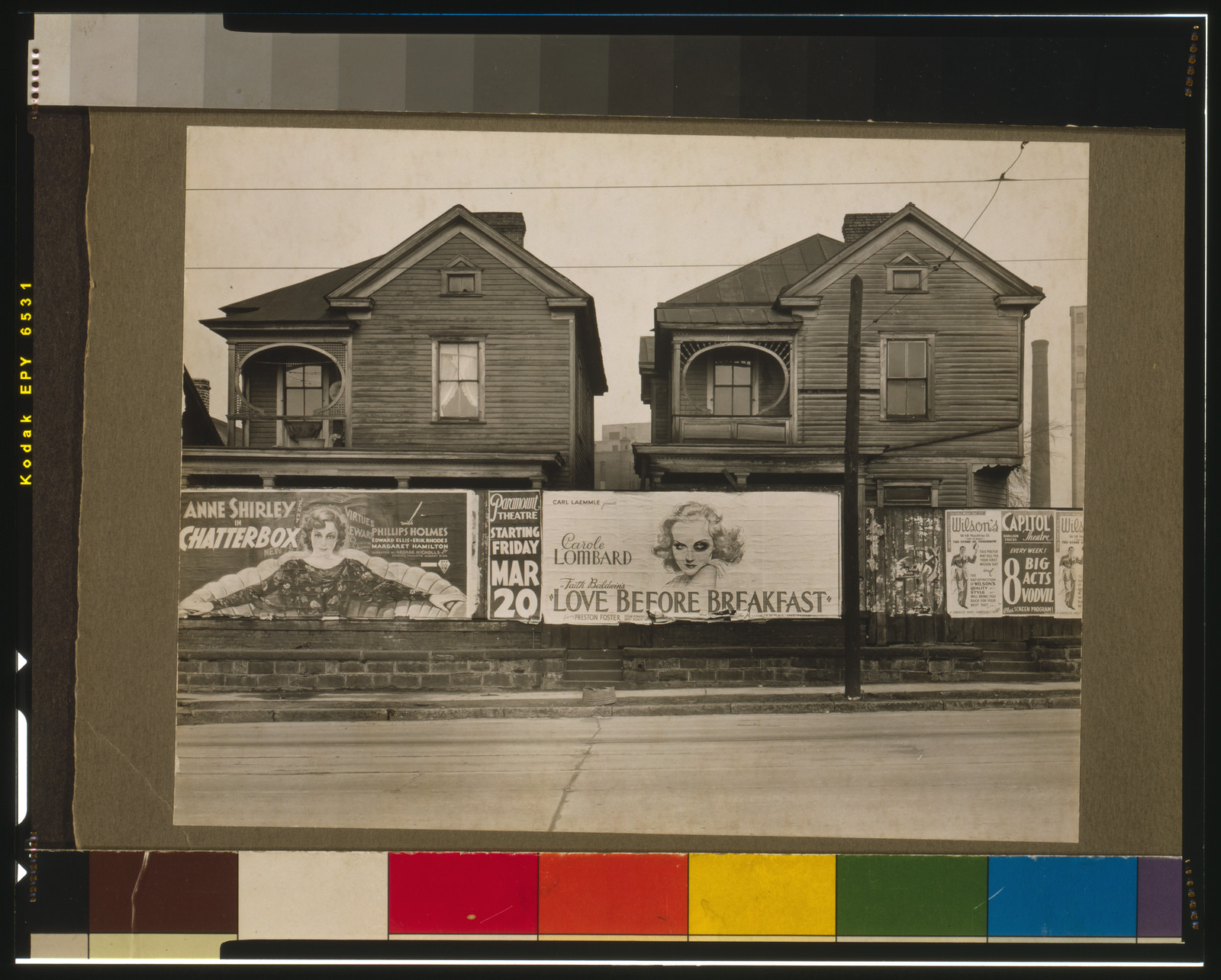 Two wooden houses behind theater posters for Love Before Breakfast — vintage poster