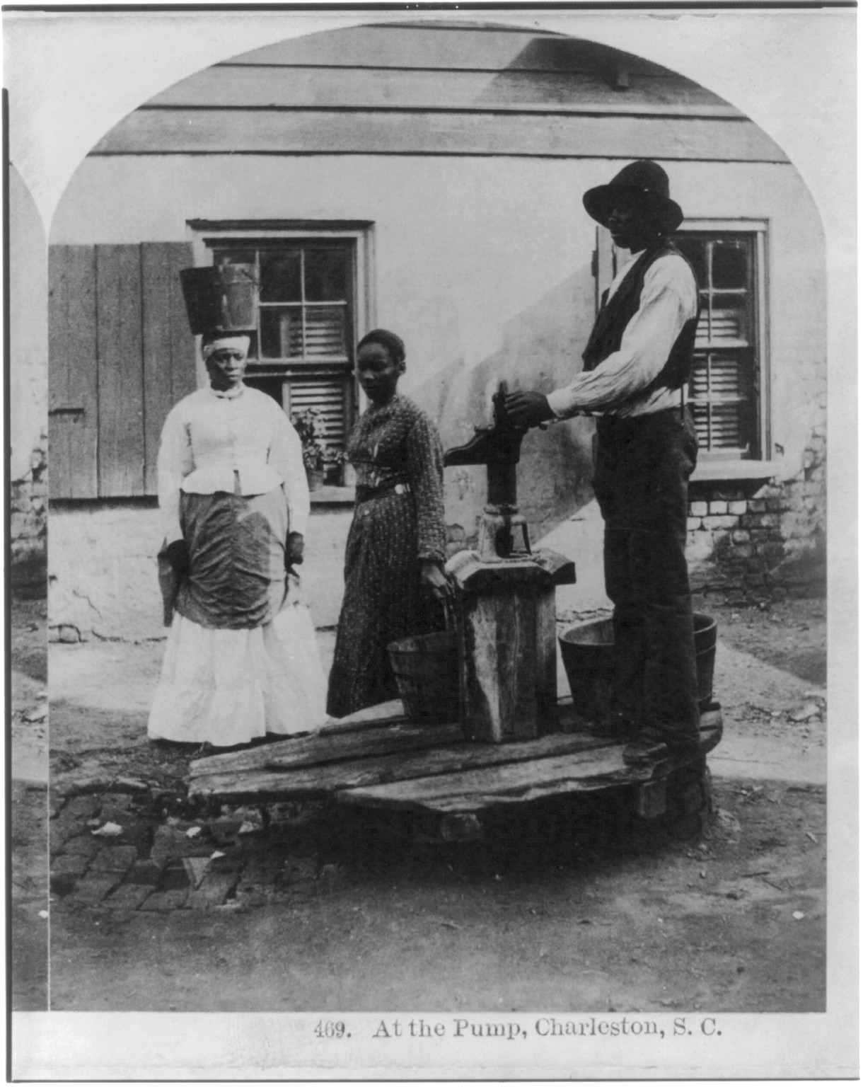 [African Americans working, Charleston, S.C.: At the pump - 3 African Americans at water pump], c1879. — historic photograph