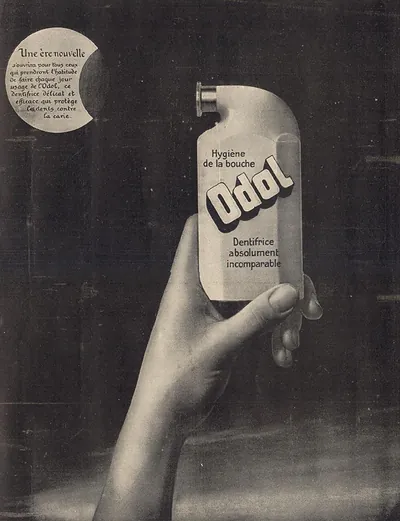 French advertisement for Odol toothpaste held in hand