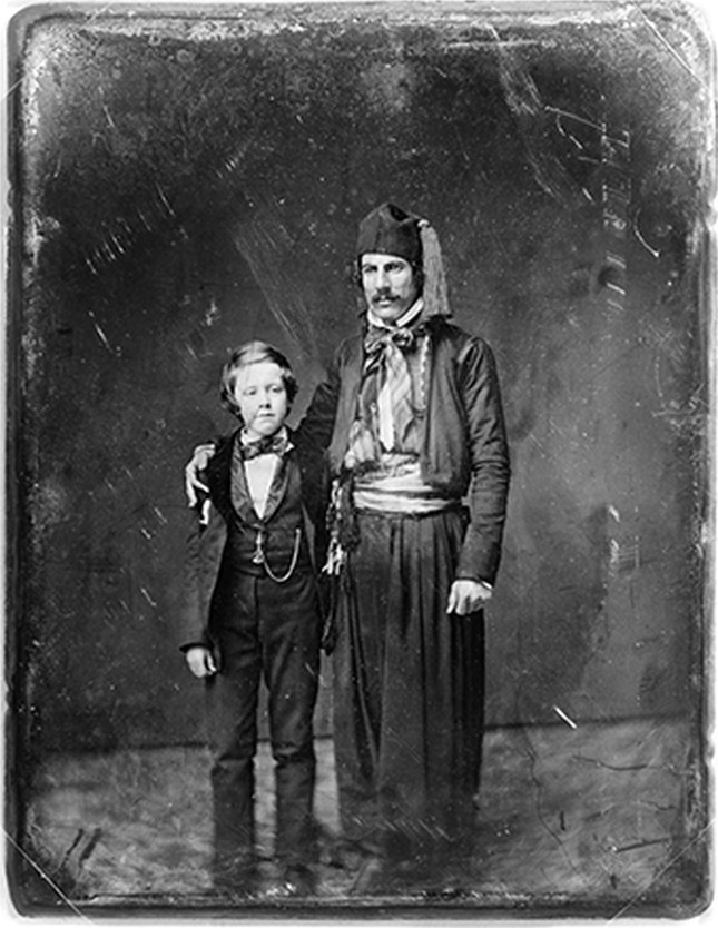 [Unidentified man in Middle Eastern costume with arm around boy, full-length portrait], [between 1844 and 1860] — historic photograph