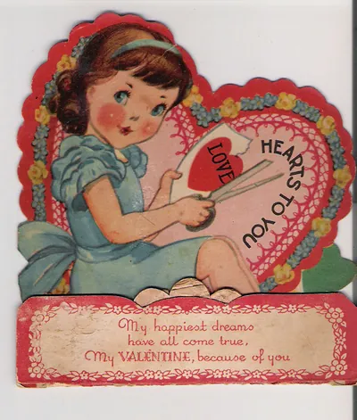 Die-cut valentine card of girl cutting a heart