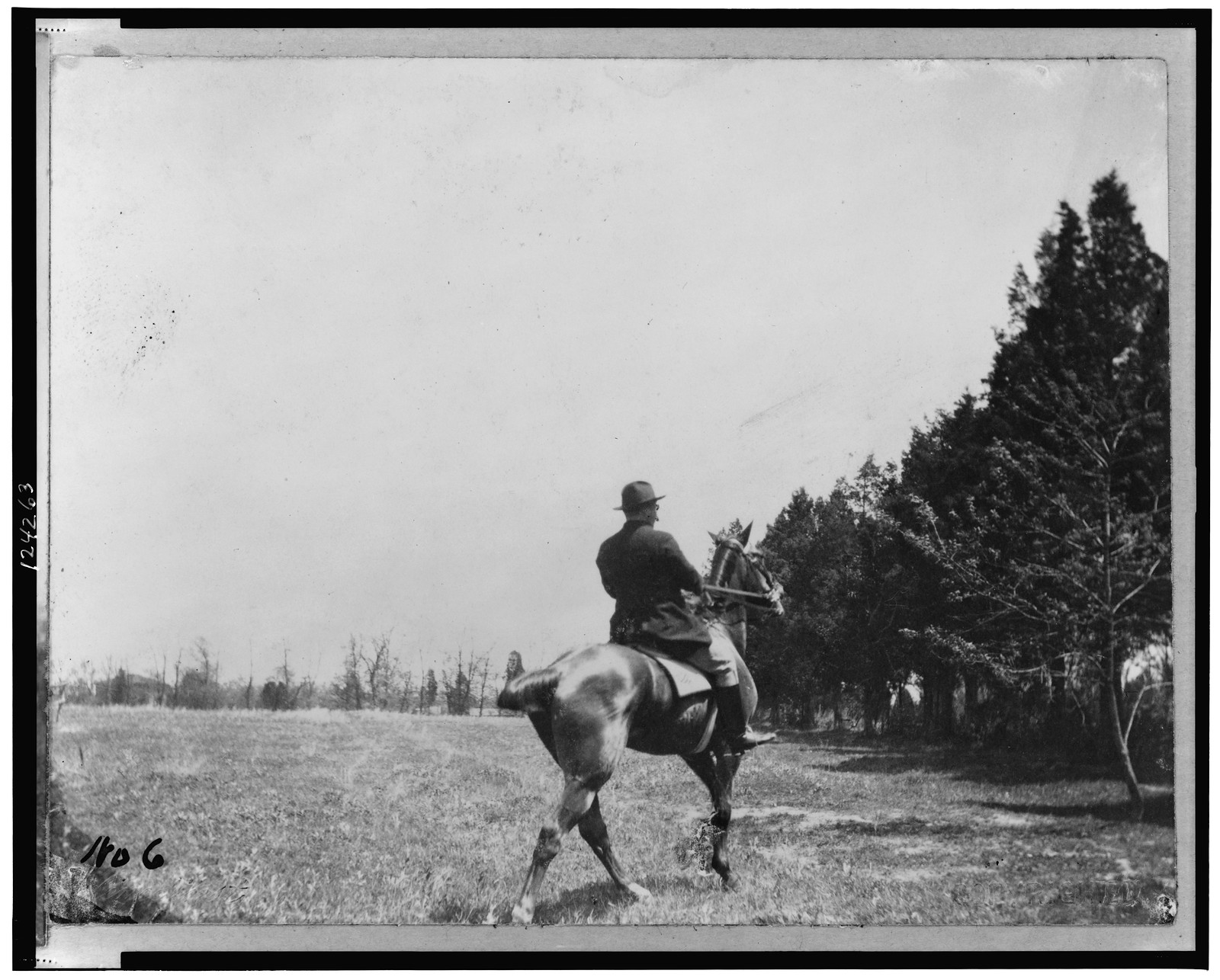 [Theodore Roosevelt, on horseback, rear view], c1902. — historic photograph