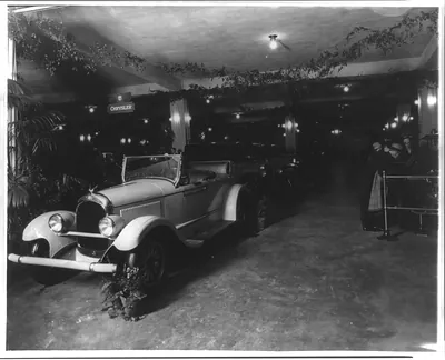 [Exhibits at an unidentified auto show, probably in Washington, D.C., Chrysler convertible in foreground]