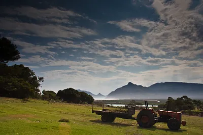Red tractor with trailer in a grassy field