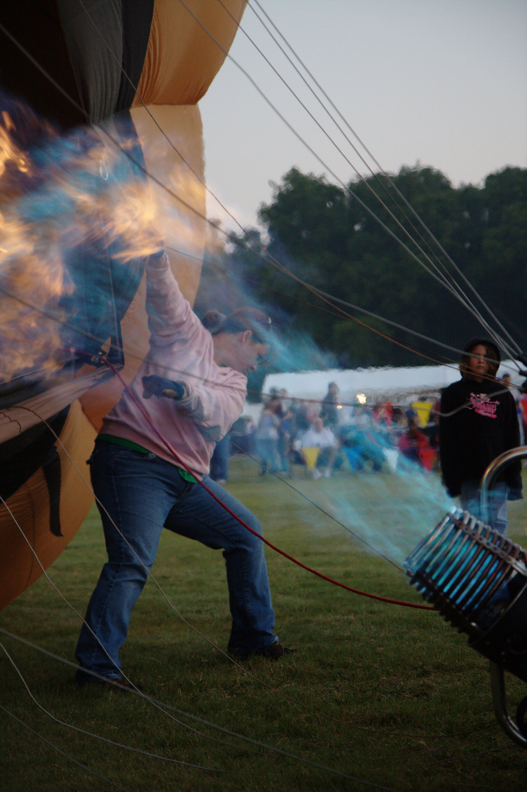 Hot air balloon being inflated with burner flame — historic image