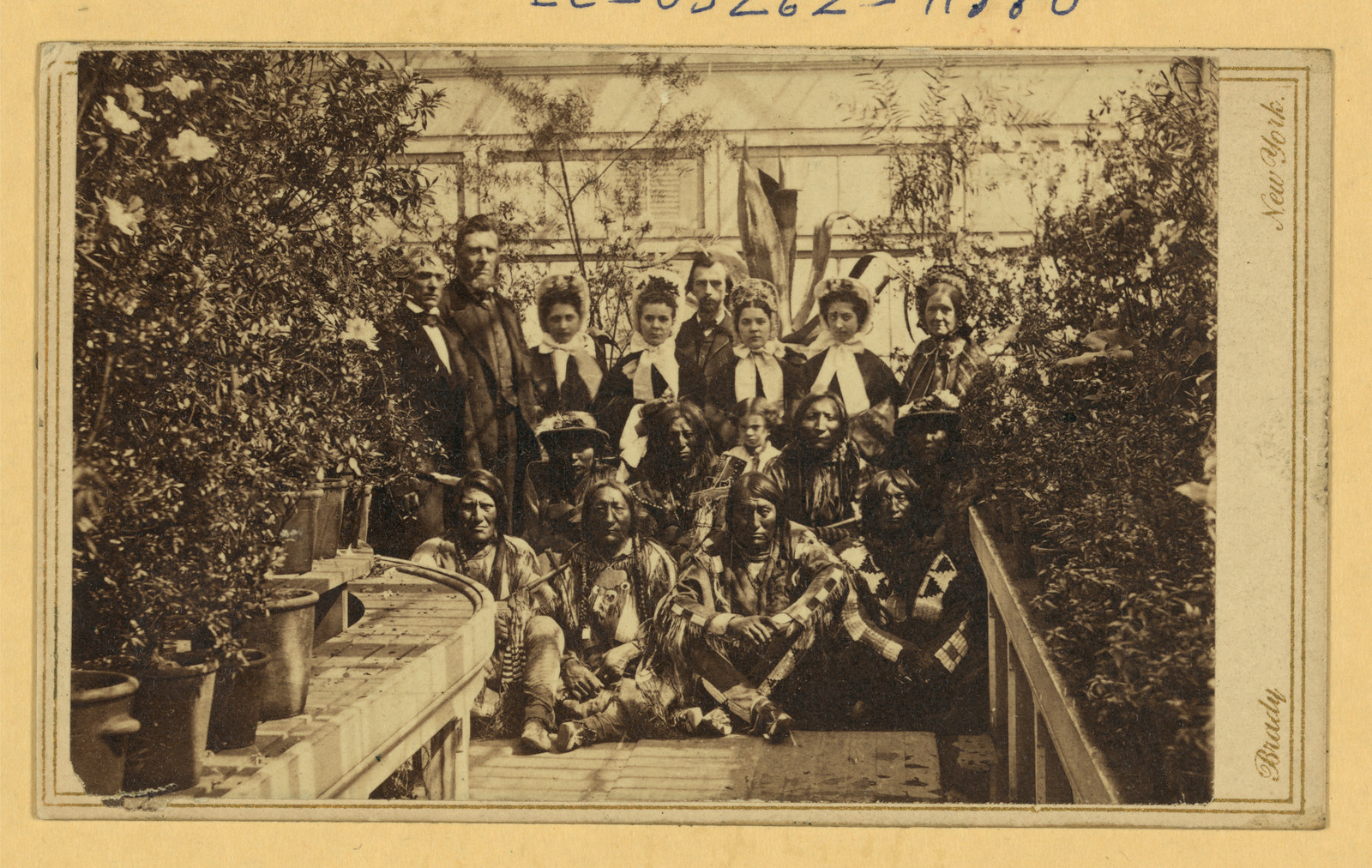 Native American men with a group in a greenhouse, Brady photograph — historic photograph