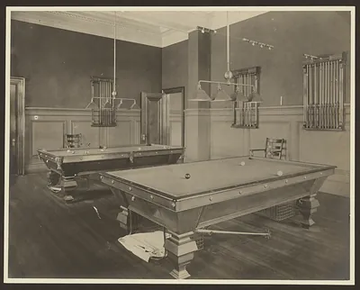 Billiard room with two pool tables and cue racks