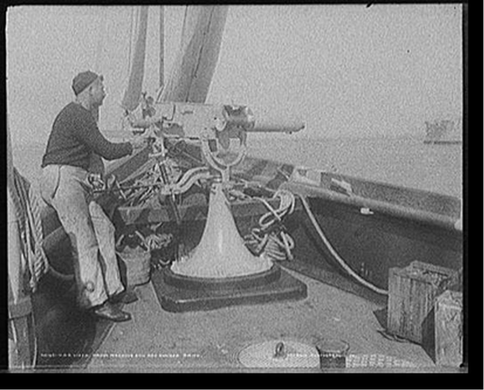 U.S.S. Vixen, Maxim machine gun and gunner Smith, [between 1898 and 1901] — historic photograph