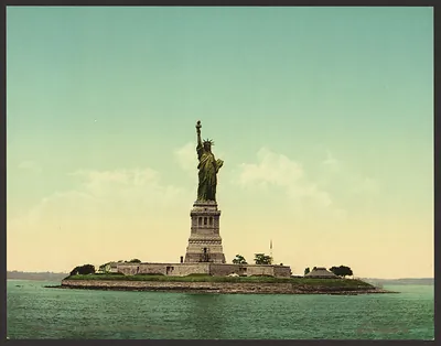 Statue of Liberty on its island, hand-colored photochrome print