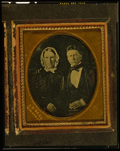 [Unidentified couple, the man with right arm around the woman's shoulder]