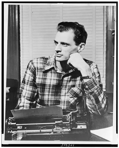 [Arthur Miller, half-length portrait, seated at typewriter, facing left, left hand under chin]