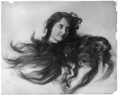 [Young woman modeling: Head, framed in flowing hair]