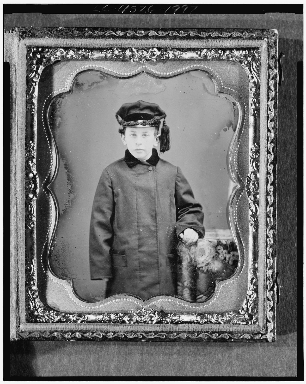 [George Leverett Stowell as a boy, three-quarter length portrait, standing, full face, with hand on table with tablecloth], [ca. 1855] — historic photograph