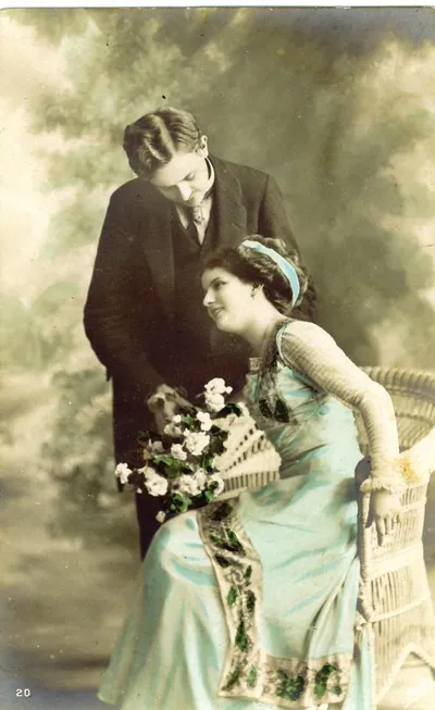 Hand-colored postcard of a couple with flowers